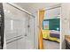 Shower and part of the bedroom with yellow curtain, ceiling fan, and neutral walls at 4352 Browns Creek Ave, North Las Vegas, NV 89084