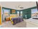 Comfortable bedroom with green walls, ceiling fan, two windows, and cozy decor at 4352 Browns Creek Ave, North Las Vegas, NV 89084