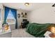 Carpeted bedroom featuring a large window, neutral walls, and a comfortable twin bed at 4352 Browns Creek Ave, North Las Vegas, NV 89084