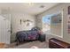 A bright bedroom featuring a twin bed with a large window for natural light at 4352 Browns Creek Ave, North Las Vegas, NV 89084