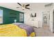 Comfortable bedroom features a ceiling fan, TV, and access to a bathroom at 4352 Browns Creek Ave, North Las Vegas, NV 89084