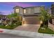 Charming two-story home featuring a well-manicured lawn, landscaped garden, and a paved driveway at 4352 Browns Creek Ave, North Las Vegas, NV 89084