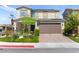 Attractive two-story home boasting a well-kept yard, brick driveway, and an attached two-car garage at 4352 Browns Creek Ave, North Las Vegas, NV 89084