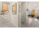 Bright hallway featuring decorative wall art, carpet, and tile flooring at 4352 Browns Creek Ave, North Las Vegas, NV 89084