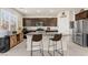 Modern kitchen featuring granite countertops, stainless steel appliances, and a large island with seating at 4352 Browns Creek Ave, North Las Vegas, NV 89084