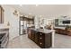 A bright kitchen featuring an island with seating, stainless steel appliances, and seamless flow into the living space at 4352 Browns Creek Ave, North Las Vegas, NV 89084