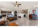 An open-concept living room with tile floors, dark wood kitchen cabinets, and bright natural light at 4352 Browns Creek Ave, North Las Vegas, NV 89084