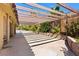 Serene backyard patio with shaded pergola, brick accents, and lush greenery at 4360 Flandes St, Las Vegas, NV 89121