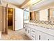 Spacious bathroom featuring mosaic floors, double doors, and white cabinets at 4360 Flandes St, Las Vegas, NV 89121