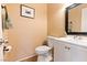 Elegant powder room featuring a stylish vanity, a contemporary mirror, and terracotta tile flooring at 4360 Flandes St, Las Vegas, NV 89121