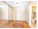 Neutral bedroom featuring a mirrored closet, terracotta floors, and an ensuite bathroom at 4360 Flandes St, Las Vegas, NV 89121
