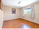 Cozy bedroom with warm hardwood floors, a bright window, and a serene atmosphere at 4360 Flandes St, Las Vegas, NV 89121