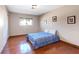 Cozy bedroom with hardwood floors, closet space, and a comfortable bed at 4360 Flandes St, Las Vegas, NV 89121