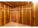 Walk-in closet featuring wood paneling, and wall-mounted shelving at 4360 Flandes St, Las Vegas, NV 89121