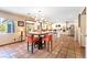 Dining room showcasing a modern chandelier and terracotta tile flooring, connecting to the kitchen at 4360 Flandes St, Las Vegas, NV 89121