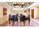 Dining room features a wooden table, tile floor, modern decor, and mirrored ceiling at 4360 Flandes St, Las Vegas, NV 89121