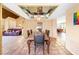 Open-concept dining room with a large wooden table, tile flooring, and mirrored ceiling at 4360 Flandes St, Las Vegas, NV 89121