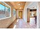 Hallway featuring a wood-paneled ceiling, tiled floor, windows, and a decorative front door at 4360 Flandes St, Las Vegas, NV 89121