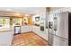 Kitchen with stainless steel appliances, white cabinets, and terracotta tile flooring at 4360 Flandes St, Las Vegas, NV 89121