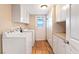 Bright laundry room with washer, dryer, ample storage cabinets and easy access to backyard at 4360 Flandes St, Las Vegas, NV 89121