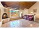 Comfortable living room with a fireplace, window seating, wood ceilings and tiled flooring at 4360 Flandes St, Las Vegas, NV 89121