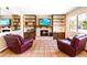 Cozy living room featuring built-in shelves, a fireplace, tiled floor, and comfy seating at 4360 Flandes St, Las Vegas, NV 89121