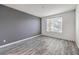 Stylish bedroom features a sleek gray accent wall and wood-look flooring at 4516 Townwall St, Las Vegas, NV 89115