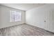 Bright bedroom featuring durable wood-look flooring, a window and white trim at 4516 Townwall St, Las Vegas, NV 89115