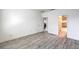 Bright bedroom featuring wood-look flooring and an ensuite bathroom with tub and shower at 4516 Townwall St, Las Vegas, NV 89115