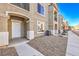 Exterior shot of a modern townhome featuring a front door with adjacent landscaping rocks at 4516 Townwall St, Las Vegas, NV 89115
