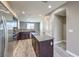 Modern kitchen with stainless steel appliances and an island with granite countertop at 4516 Townwall St, Las Vegas, NV 89115