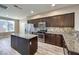 Kitchen with an island, stainless steel appliances, granite counters, and wooden cabinetry at 4516 Townwall St, Las Vegas, NV 89115