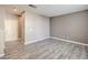 A spacious living room with modern wood flooring and a view of the front door at 4516 Townwall St, Las Vegas, NV 89115