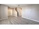 Large living room featuring wood-look flooring and stair access at 4516 Townwall St, Las Vegas, NV 89115