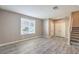 Bright living room featuring wood floors, a large window, and convenient access to the staircase at 4516 Townwall St, Las Vegas, NV 89115
