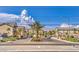 Beautiful community entrance with lush landscaping, palm trees, and scenic mountain views at 4516 Townwall St, Las Vegas, NV 89115