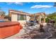 Backyard patio with a hot tub, mature landscaping, an outdoor seating area, and an exterior view of the home at 4631 Forest Shadow Ave, Las Vegas, NV 89139
