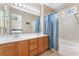Bathroom featuring a double sink vanity, and a shower-tub with blue curtain at 4631 Forest Shadow Ave, Las Vegas, NV 89139