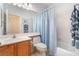 Full bathroom with sink, toilet, bathtub with shower, and blue accents at 4631 Forest Shadow Ave, Las Vegas, NV 89139