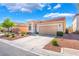 Attractive single-level house with tidy landscaping, a concrete driveway, and an attached two-car garage under a bright sky at 4631 Forest Shadow Ave, Las Vegas, NV 89139