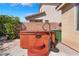 Hot tub on a private patio, adjacent to a well-maintained wall and lush greenery in the backyard at 4631 Forest Shadow Ave, Las Vegas, NV 89139