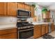 Well-equipped kitchen featuring stainless steel appliances, tile countertops and wooden cabinets at 4631 Forest Shadow Ave, Las Vegas, NV 89139