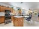 Open kitchen showcases stainless appliances, wooden cabinetry, and cozy breakfast nook at 4631 Forest Shadow Ave, Las Vegas, NV 89139