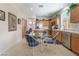 Open-concept kitchen features stainless appliances, wooden cabinets, and a breakfast nook table at 4631 Forest Shadow Ave, Las Vegas, NV 89139
