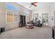 Expansive living room featuring tall windows, neutral carpeting, and comfortable furniture, perfect for relaxation and entertainment at 4631 Forest Shadow Ave, Las Vegas, NV 89139