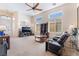 Spacious living area with plush carpeting, high ceilings, and lots of natural light streaming through the windows at 4631 Forest Shadow Ave, Las Vegas, NV 89139
