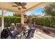 Charming covered patio features a ceiling fan, barbecue grill, and a cozy seating area for outdoor entertaining at 4631 Forest Shadow Ave, Las Vegas, NV 89139