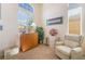 Cozy sitting area filled with natural light, showcasing a comfortable recliner and stylish decor at 4631 Forest Shadow Ave, Las Vegas, NV 89139
