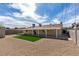 Expansive backyard featuring gravel, a small patch of grass, covered patio, and privacy provided by brick wall at 4670 E Boston Ave, Las Vegas, NV 89104