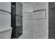 Modern bathroom shower with gray and white marble tile at 4670 E Boston Ave, Las Vegas, NV 89104